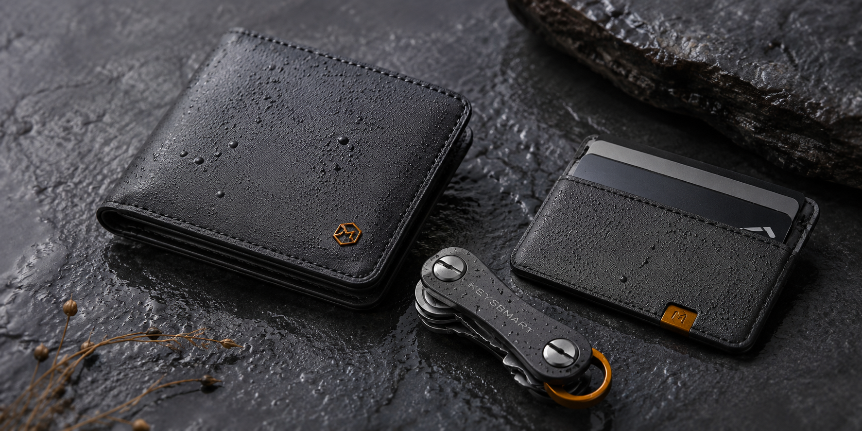 Men's slim wallet, key organizer and card holder on a wet surface
